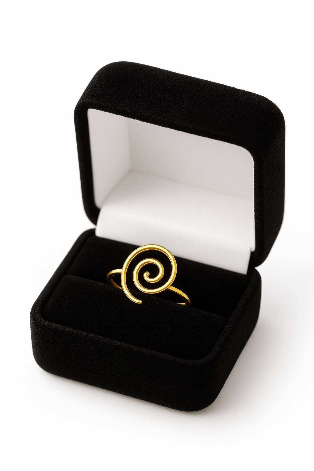 Gold spiral ring in a black velvet box on a white background