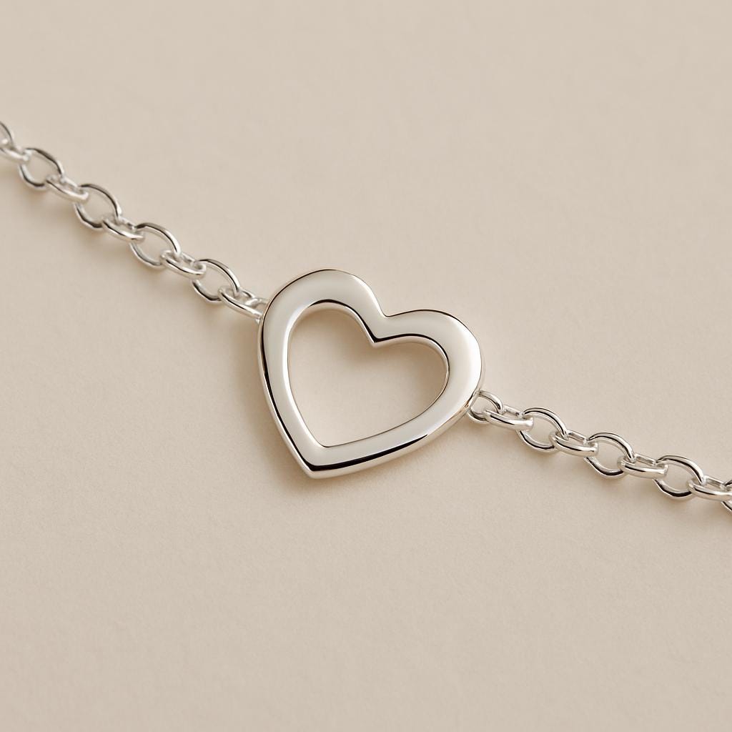 Silver heart-shaped bracelet on a beige background