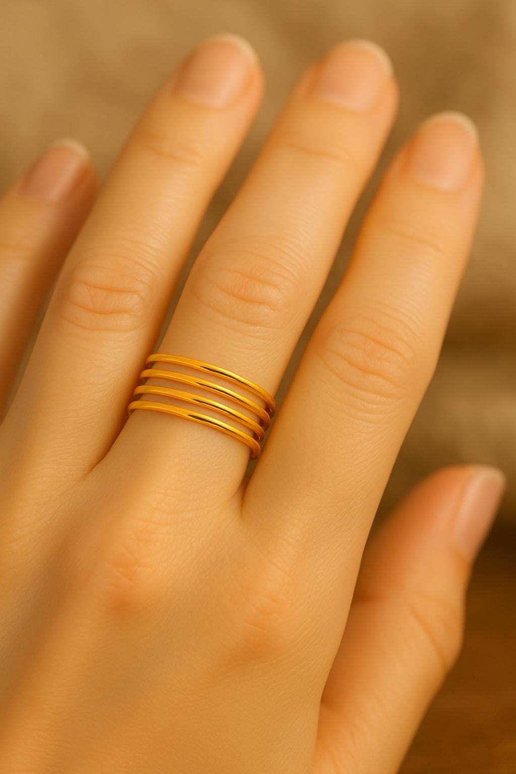 Gold ring on a person's finger with a blurred background
