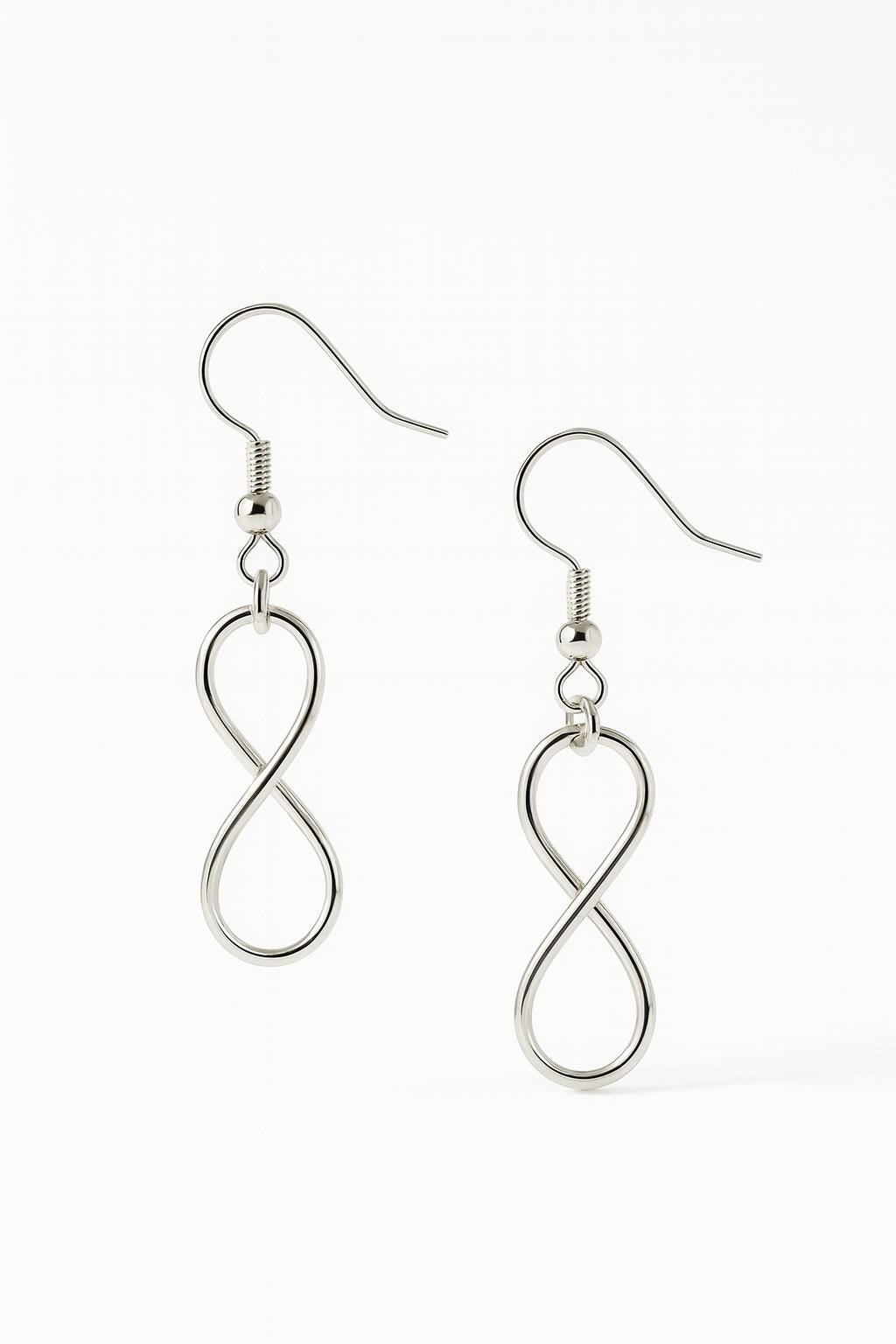 Silver infinity loop earrings on a white background