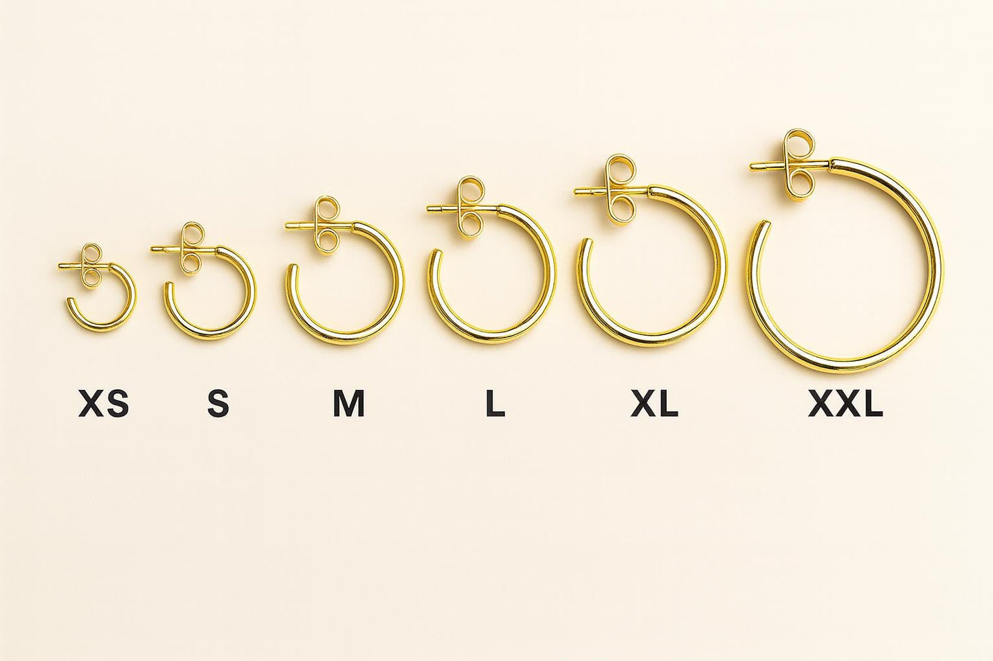 Set of gold hoop earrings in various sizes on a white background