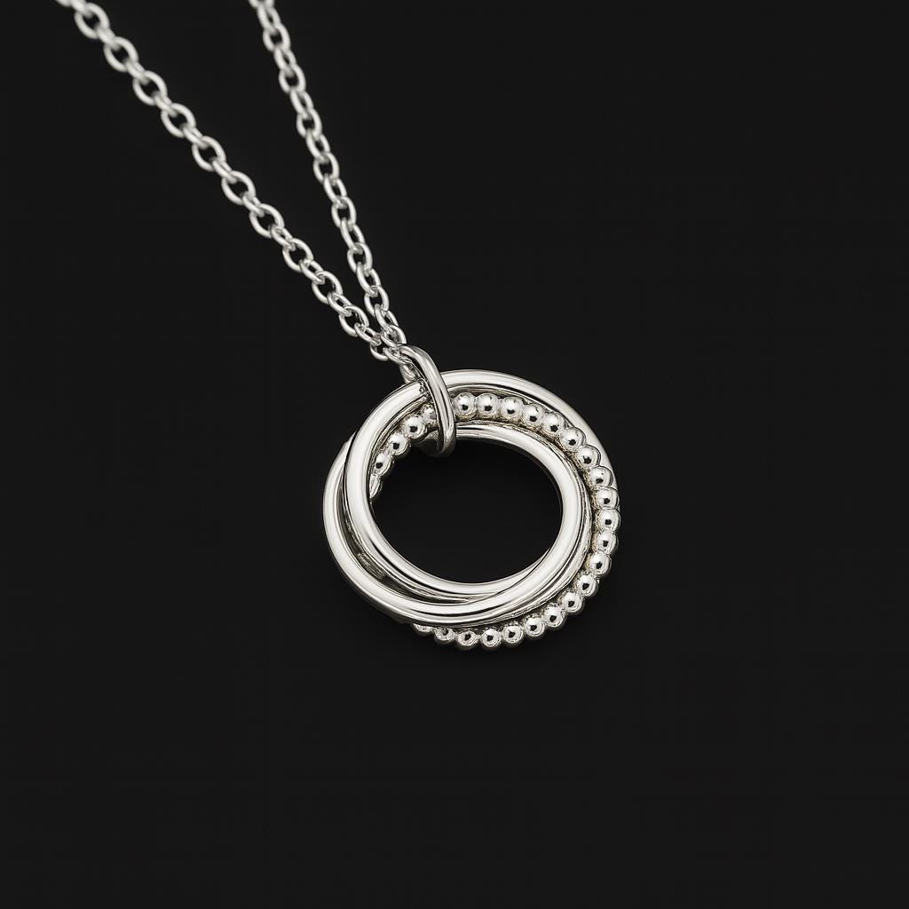 interlocking rings necklace, sterling silver pendant necklace, silver circle necklace, unity necklace, minimalist silver necklace, triple ring pendant, hammered silver necklace, beaded silver pendant, modern geometric necklace, handcrafted silver jewelry, dainty silver necklace, layering silver necklace, sterling silver chain necklace, artisan made jewelry, everyday silver jewelry, simple elegant necklace, gift for her jewelry, bridesmaid silver necklace, anniversary necklace, St Clair Fine Jewelry necklace
