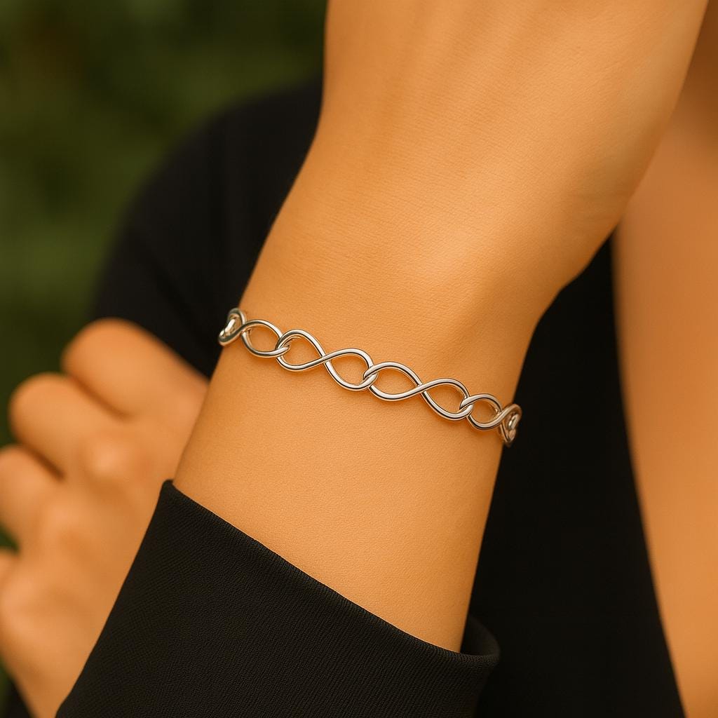 Silver chain bracelet on a wrist with a blurred background