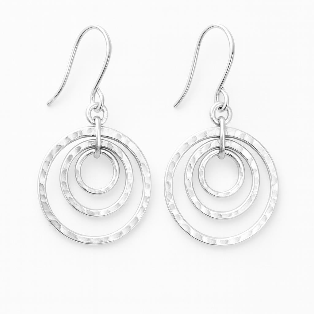 Silver hammered hoop earrings on a white background
