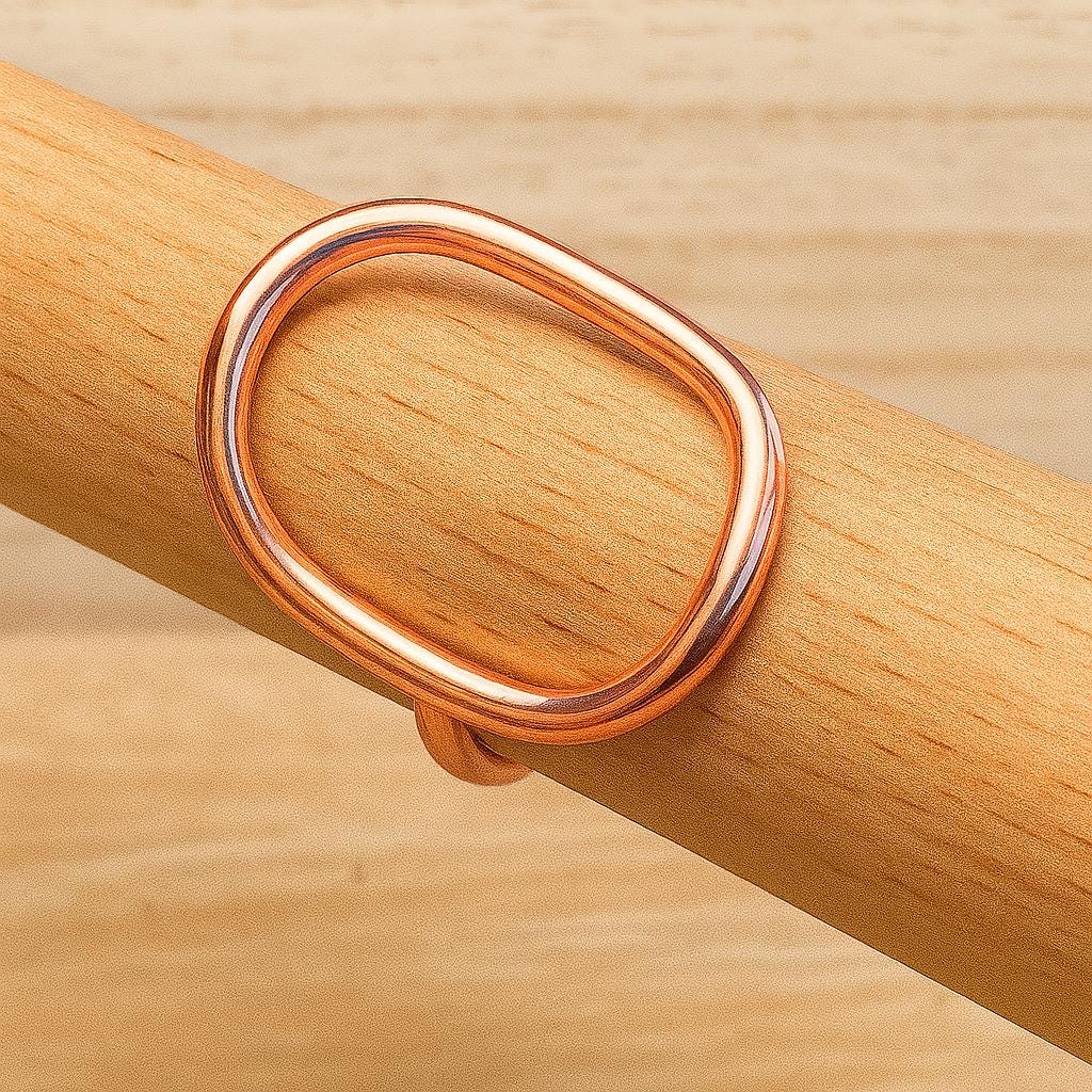 Rose gold ring on a wooden surface