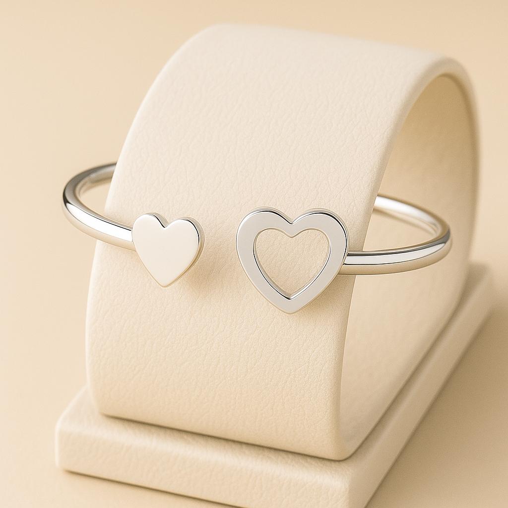Silver heart-shaped bracelet on a beige cushion