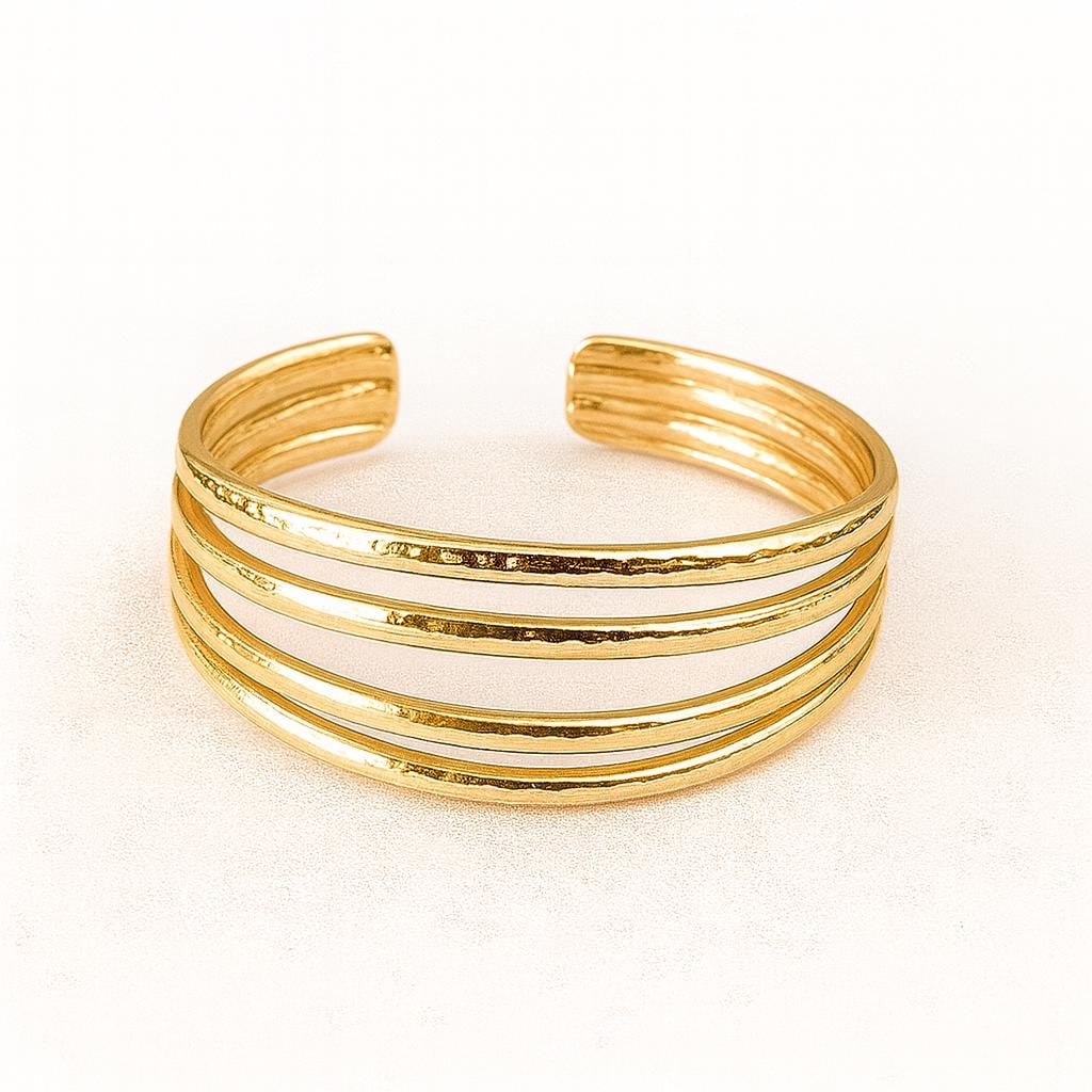 Gold 4 band hammered toe ring with multiple bands on a white background