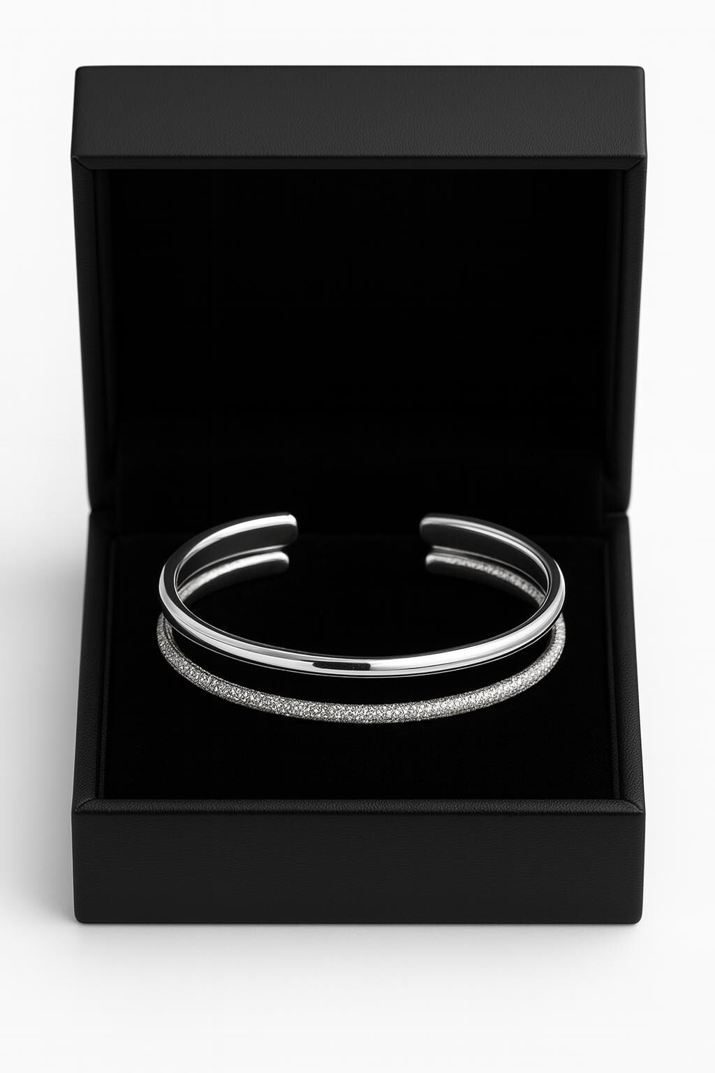 Silver bangle in a black box on a white background
