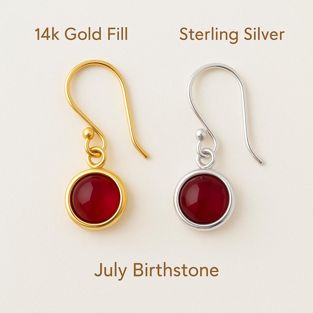 Two pairs of earrings, one gold and one silver, with red gemstones on a light background.