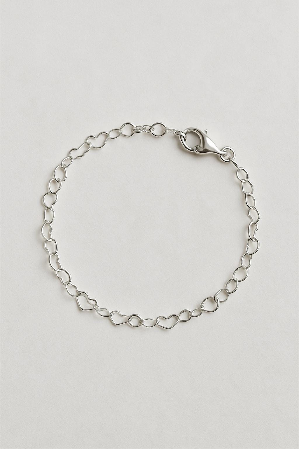 Silver chain bracelet on a light gray background