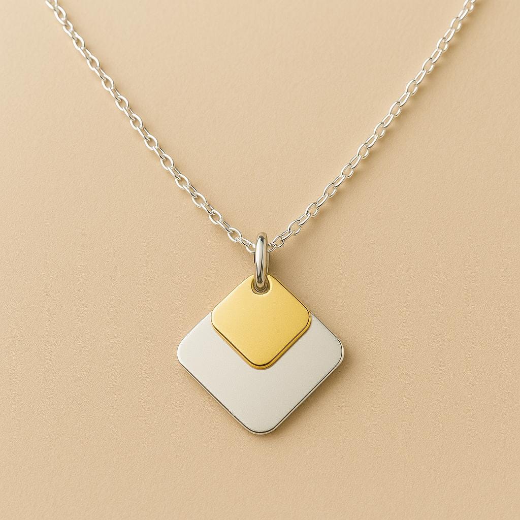 Necklace with a gold and white square pendant on a beige background