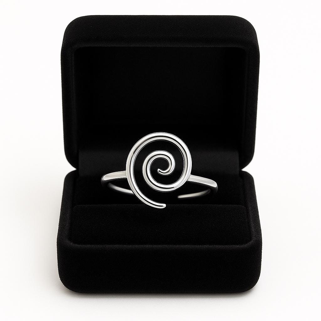 Silver spiral ring in a black jewelry box on a white background