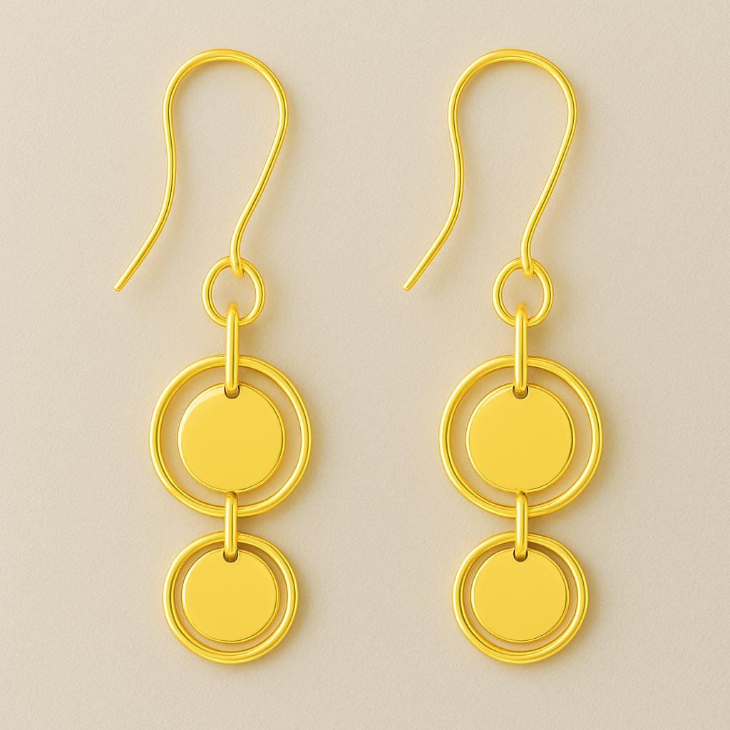 Pair of gold earrings with circular design on a beige background