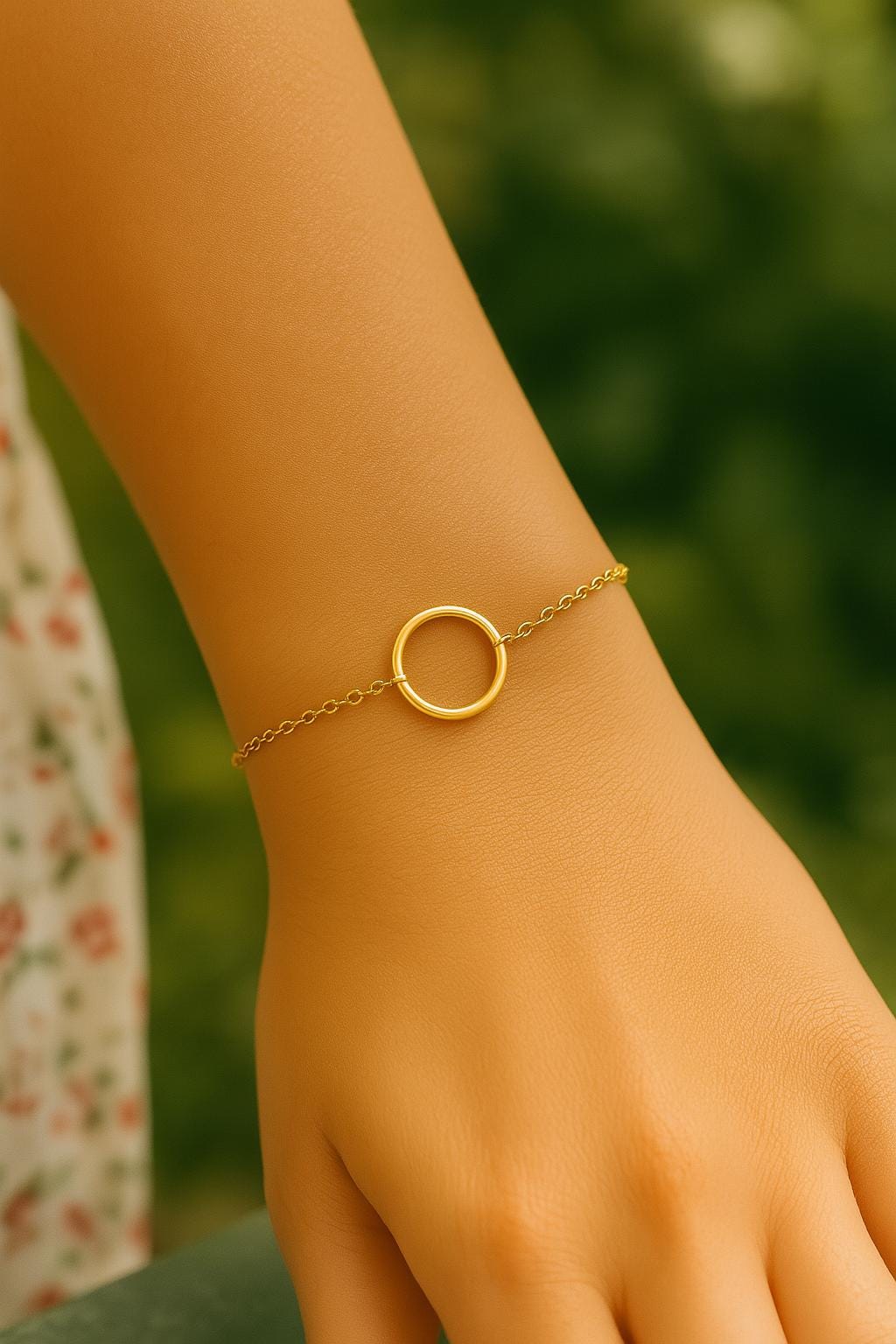 Gold bracelet on a wrist with a blurred green background