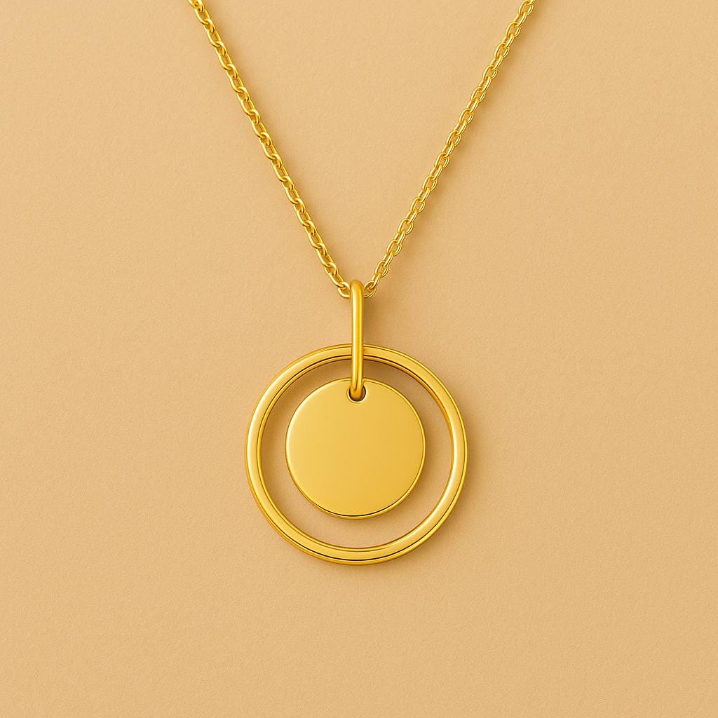 Gold necklace with a circular pendant on a beige background
