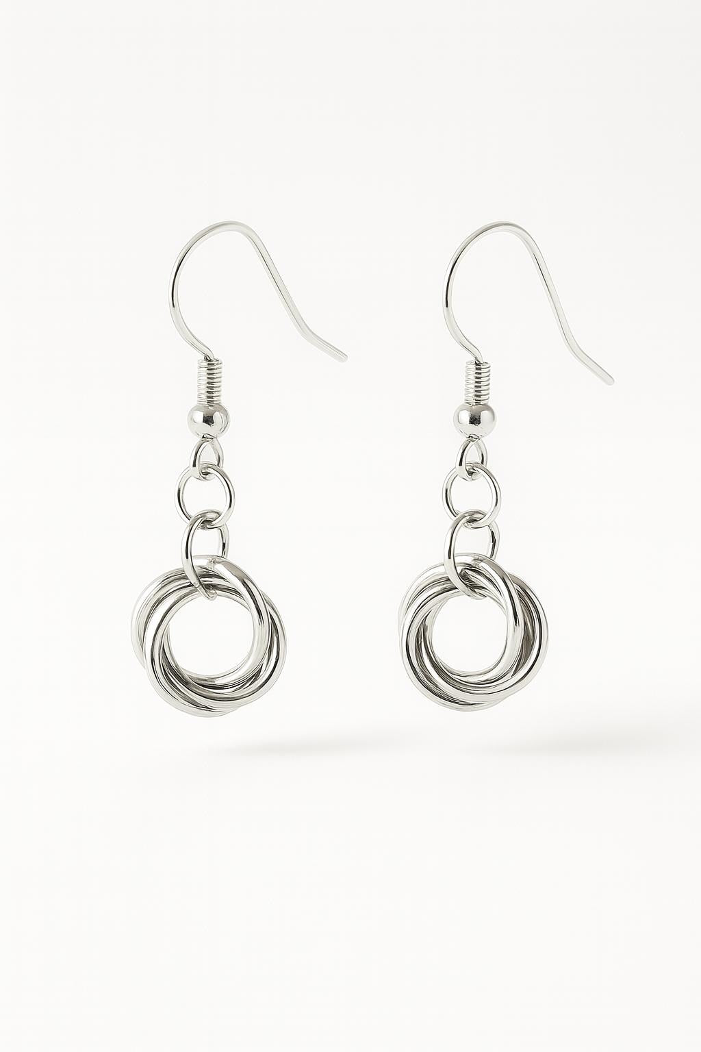 sterling silver love knot earrings, silver knot earrings, love knot dangle earrings, minimalist silver earrings, dainty sterling silver earrings, handmade silver earrings, silver drop earrings, knot earrings for women, classic silver earrings, everyday silver earrings, silver jewelry gift for her, bridesmaid earrings silver, modern romantic jewelry, handcrafted sterling silver jewelry, lightweight dangle earrings, hypoallergenic silver earrings, symbolic knot jewelry, silver anniversary gift, artisan silver