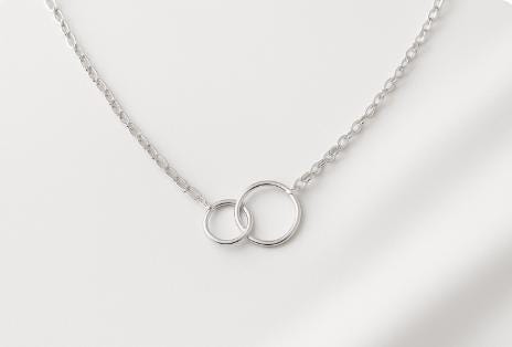 interlocking circle necklace, infinity necklace, gold filled circle necklace, sterling silver circle necklace, linked circles necklace, mother daughter necklace, friendship necklace, unity necklace, family bond jewelry, minimalist gold necklace, modern silver necklace, handcrafted circle pendant, meaningful jewelry gift, anniversary necklace, everyday gold necklace, fine handmade jewelry, St Clair Fine Jewelry necklace, dainty gold pendant, hypoallergenic jewelry, layering circle necklace, elegant silver je