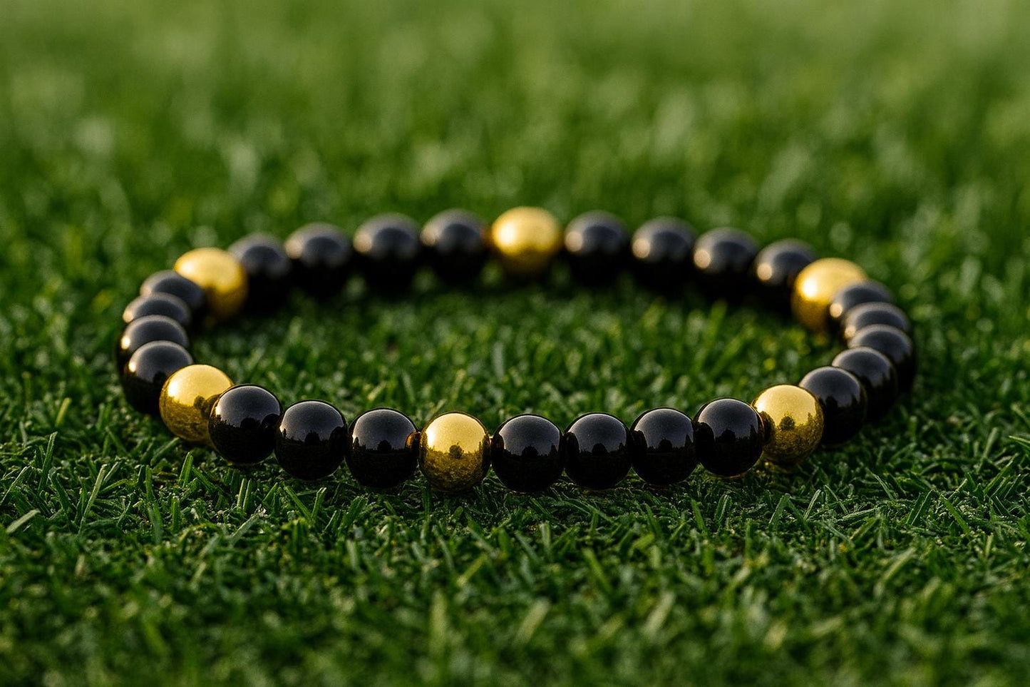 Black and gold beaded bracelet on grass