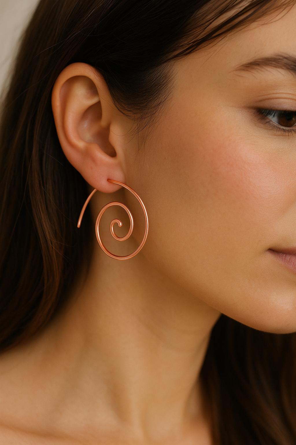 Close-up of a woman wearing a spiral earring.
