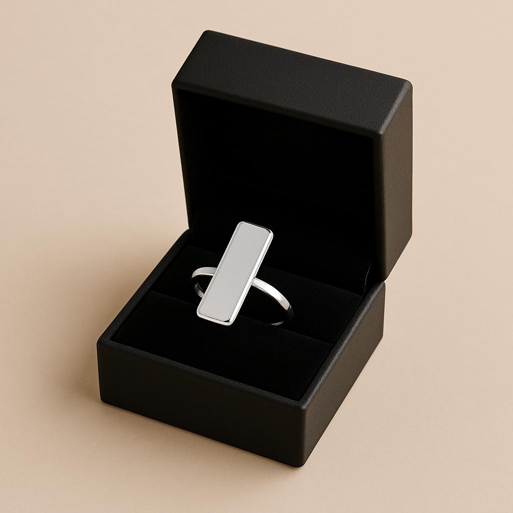Silver ring in a black box on a beige background