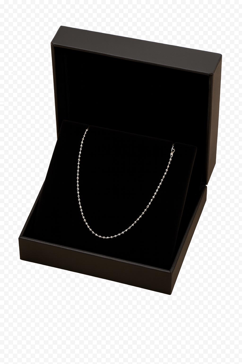Black jewelry box with a silver necklace inside on a transparent background