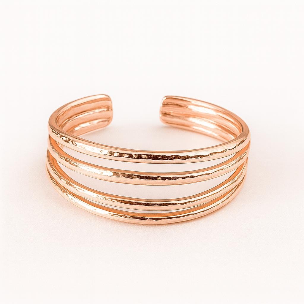Rose gold 4 band toe ring on a light pink background