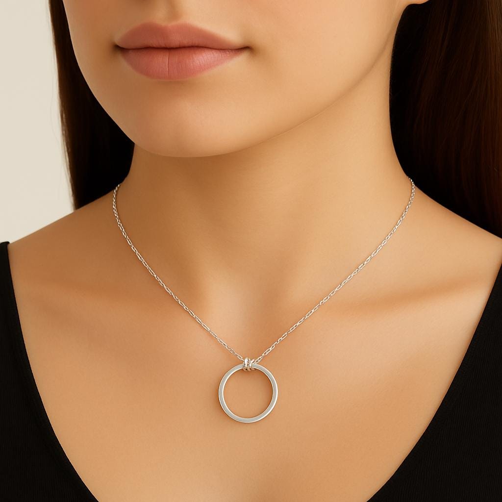 Silver necklace with a circular pendant on a model