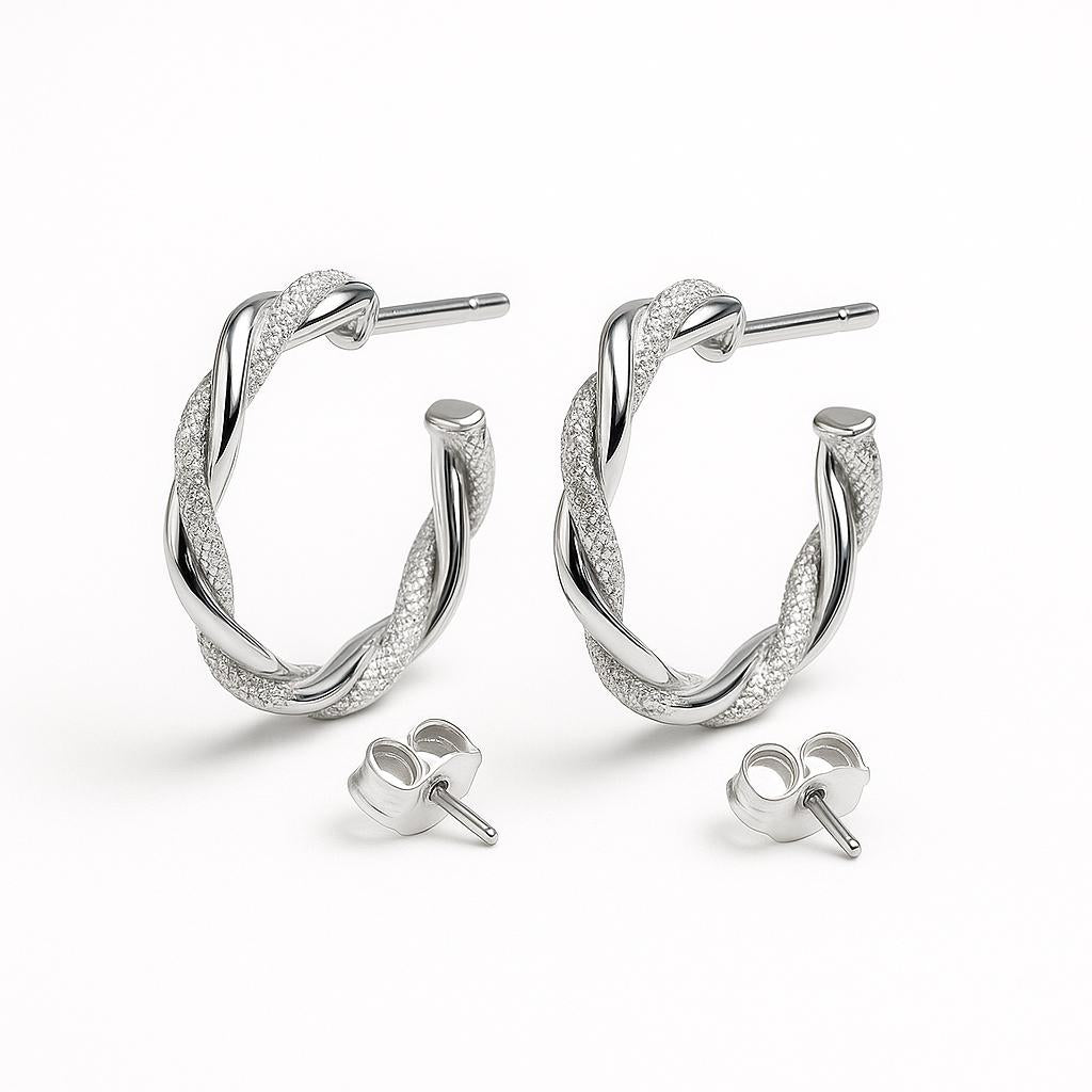 Pair of rope twist sparkle gold hoop earrings on a light gray background