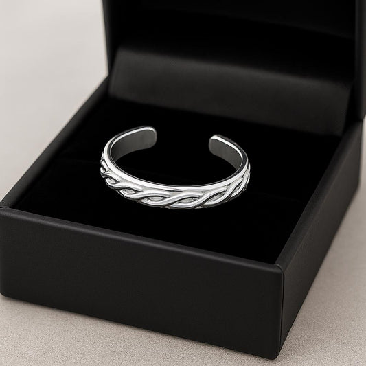 Silver bracelet in a black jewelry box on a light gray background