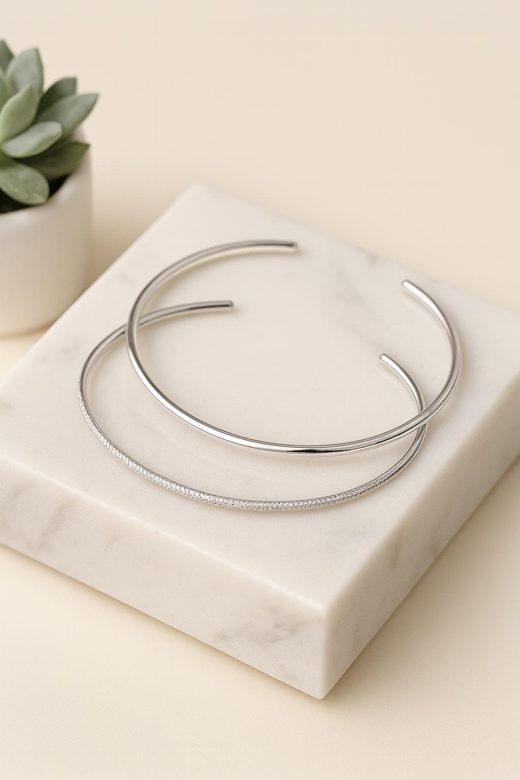 Silver bracelet on a marble surface with a light background