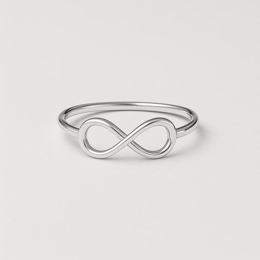 Silver infinity ring on a light gray background