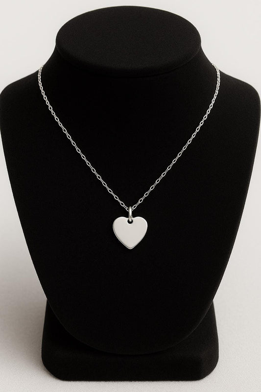 Silver heart-shaped pendant necklace on a black mannequin bust against a white background