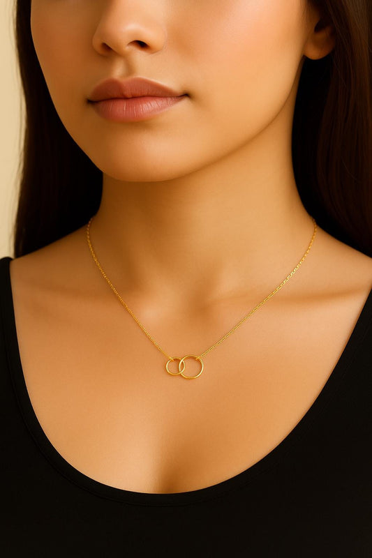 interlocking circle necklace, infinity necklace, gold filled circle necklace, sterling silver circle necklace, linked circles necklace, mother daughter necklace, friendship necklace, unity necklace, family bond jewelry, minimalist gold necklace, modern silver necklace, handcrafted circle pendant, meaningful jewelry gift, anniversary necklace, everyday gold necklace, fine handmade jewelry, St Clair Fine Jewelry necklace, dainty gold pendant, hypoallergenic jewelry, layering circle necklace, elegant silver je
