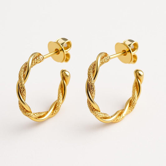 Pair of rope twist sparkle gold hoop earrings on a light gray background