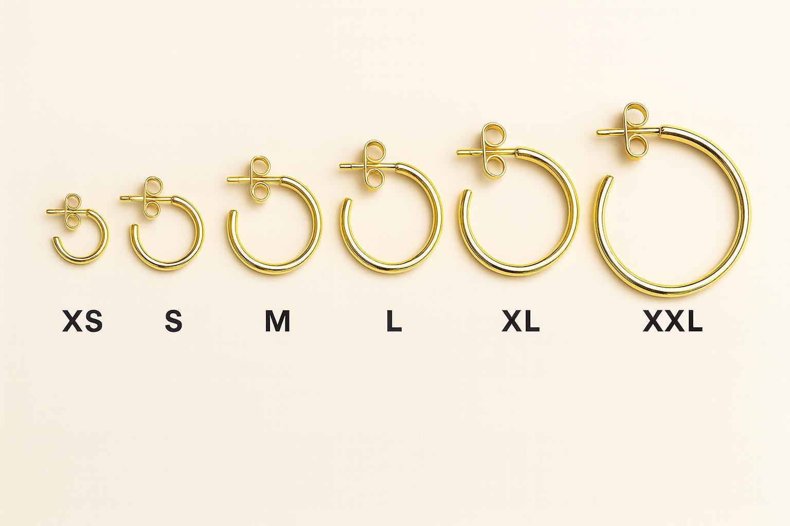 Set of gold hoop earrings in various sizes on a white background