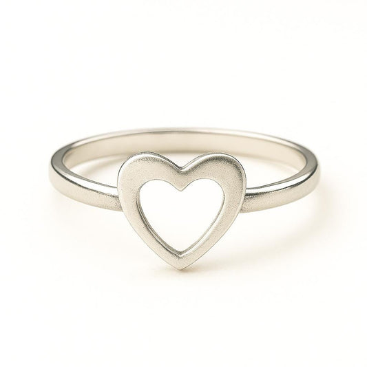 Silver ring with a heart design on a white background