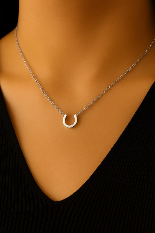 Necklace with a horseshoe pendant on a mannequin