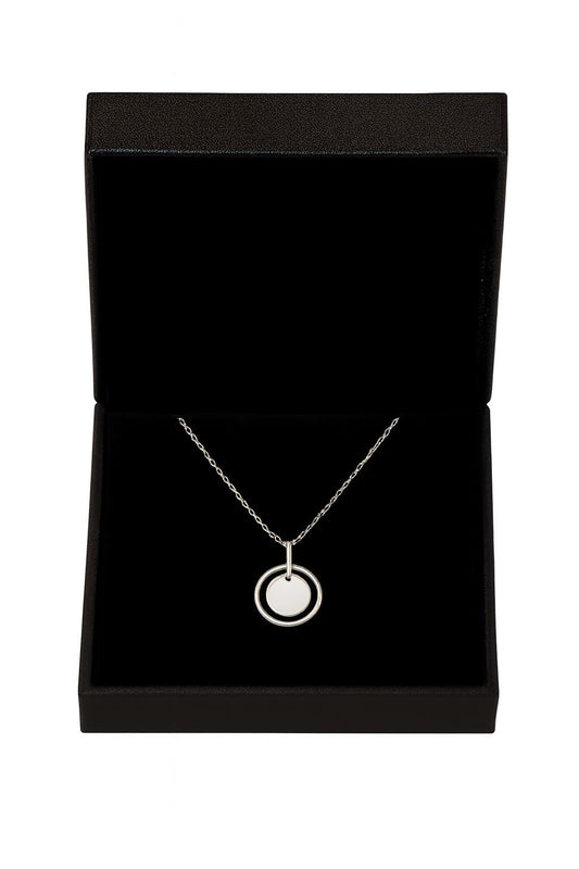 Silver necklace with a circular pendant in a black jewelry box on a white background
