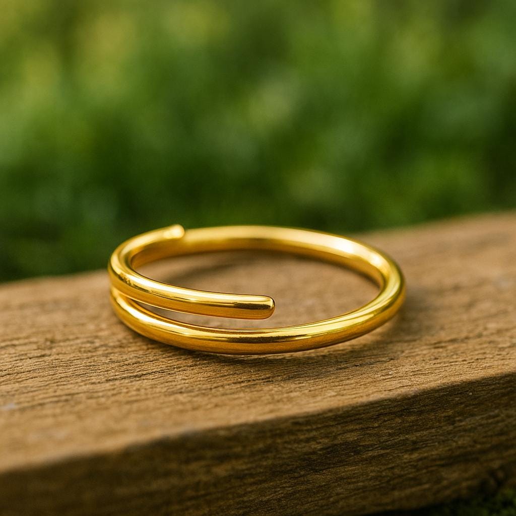 Gold ring on a wooden surface with a blurred green background