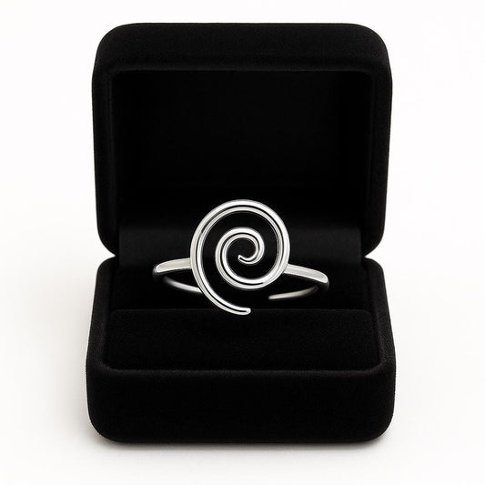 Silver spiral ring in a black jewelry box on a white background