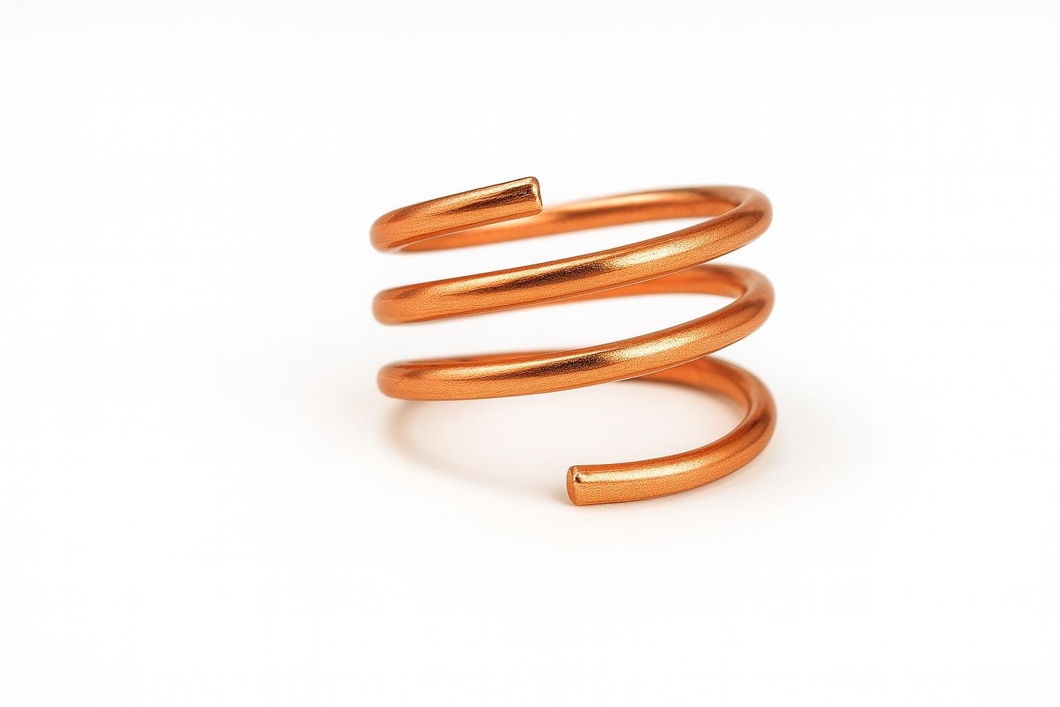 Rose gold spiral ring on a white background