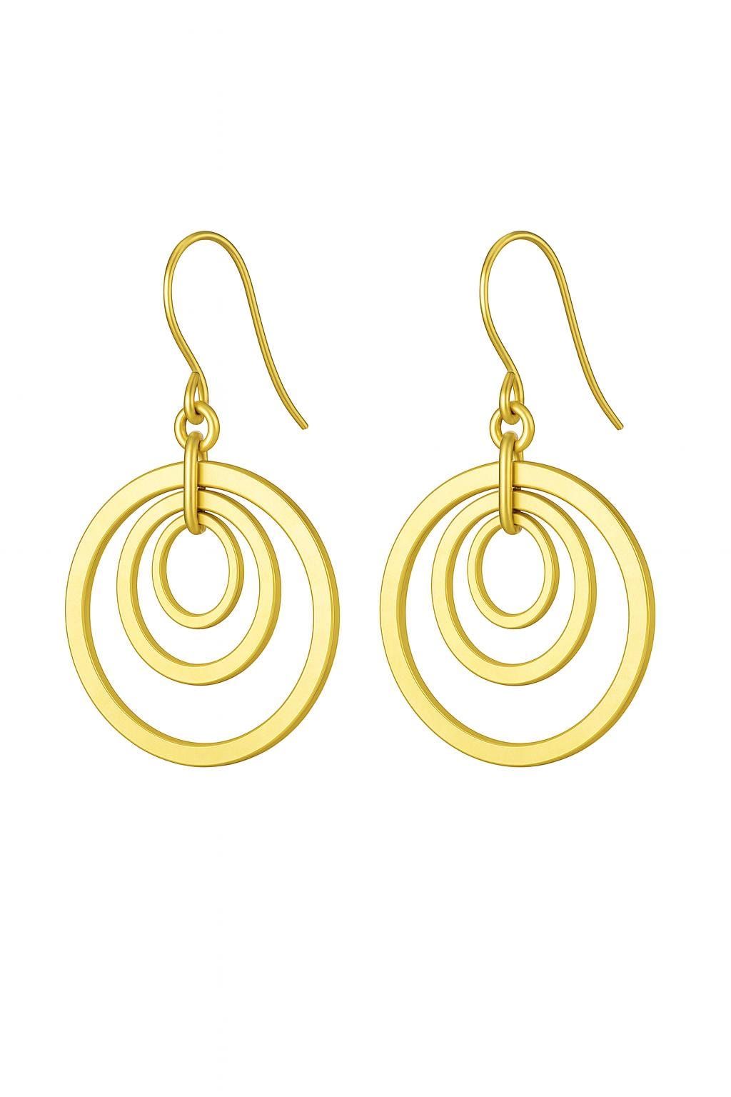 Gold Brass Dangle earrings on a textured surface with a black box in the background