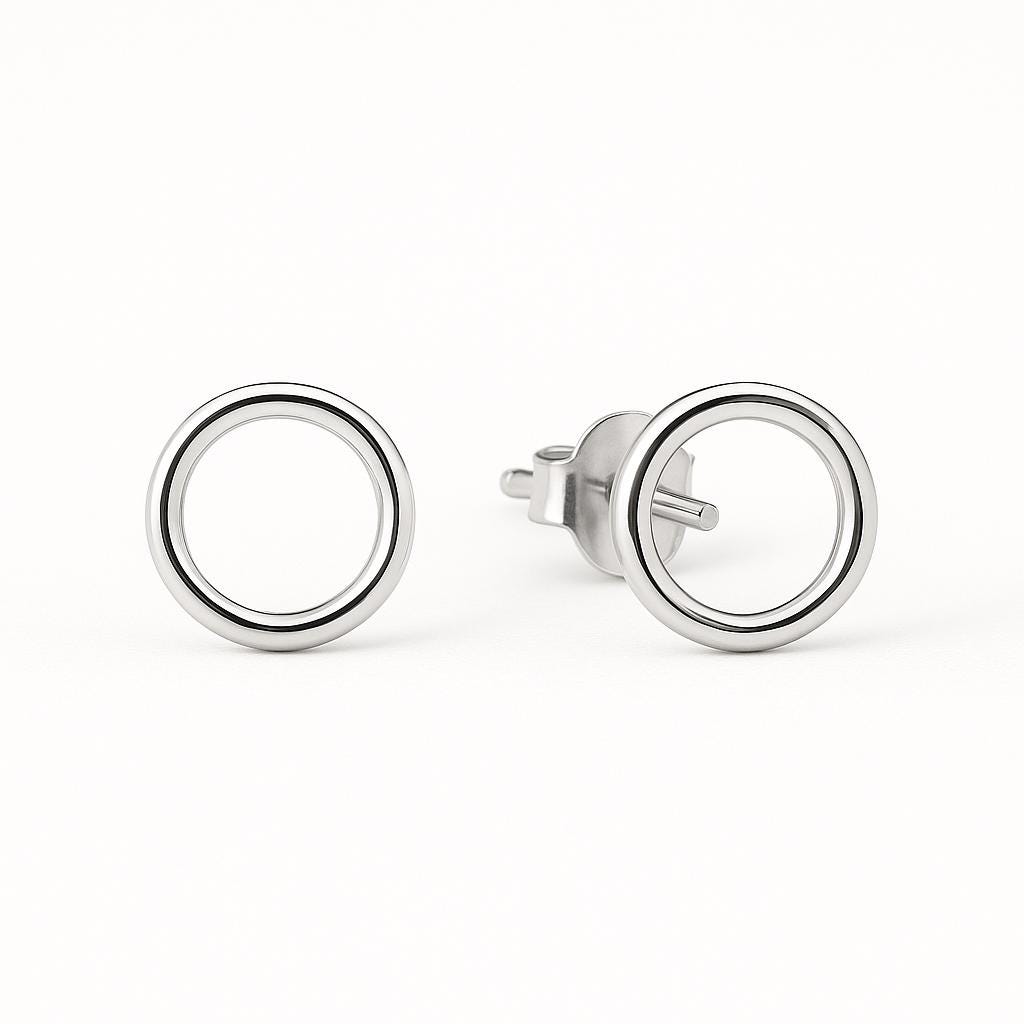 Pair of silver circular earrings on a white background