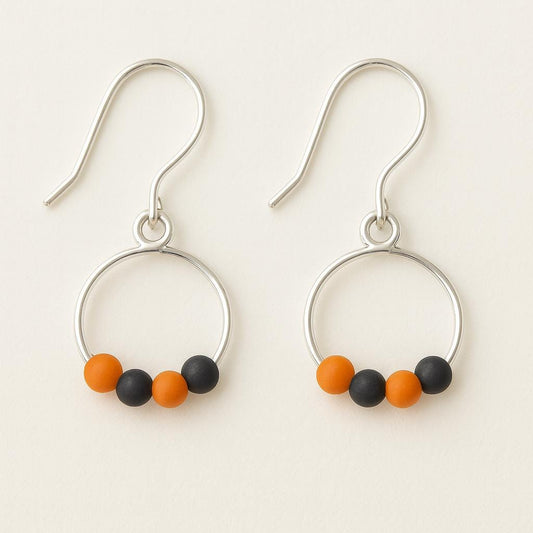 Hoop earrings with colorful beads on a light background