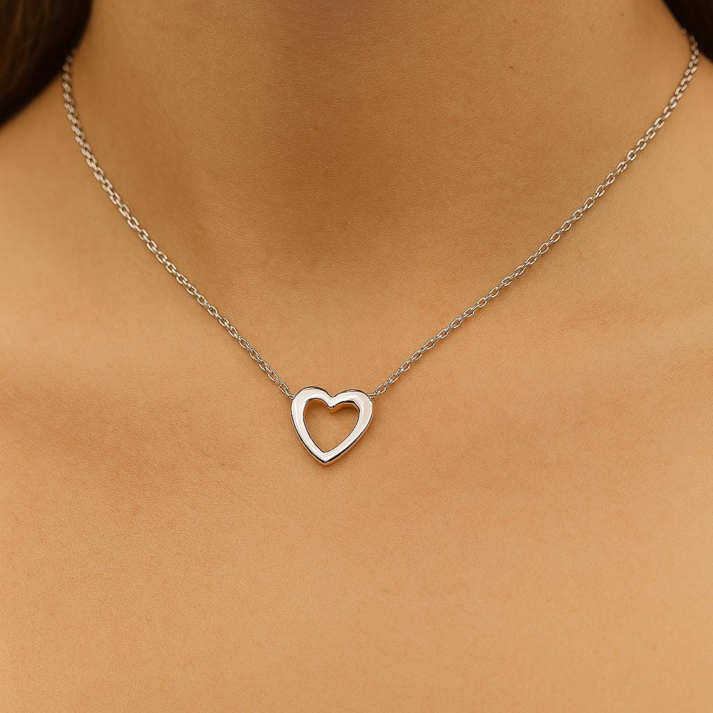 Silver heart-shaped necklace on a person's neck