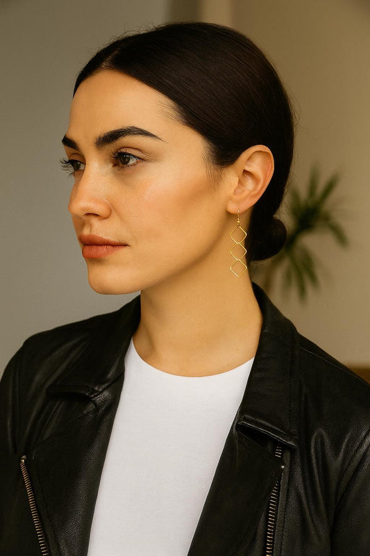 Woman wearing a black leather jacket and white shirt with a blurred background