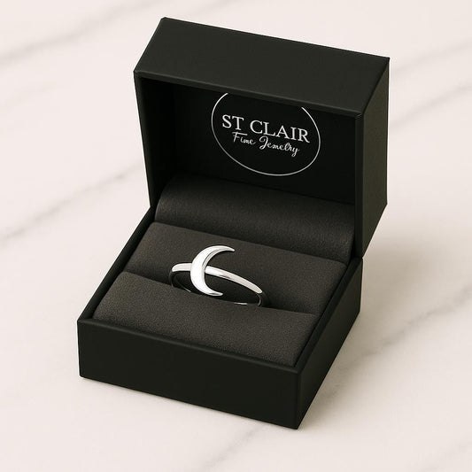 Silver crescent moon ring in a black St. Clair Fine Jewelry box on a white background