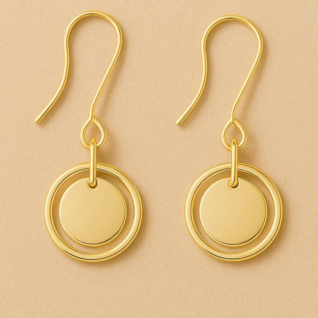 Gold earrings with circular design on a beige background